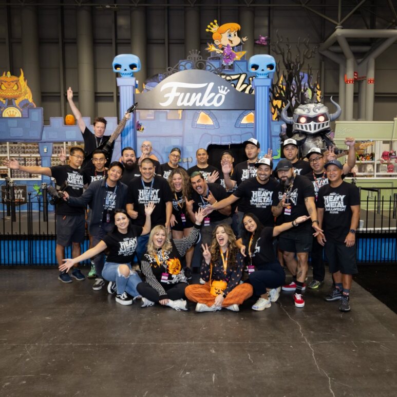 A group of Funko staff pose in front of the entrance to Funko's Heavy Metal Halloween booth at New York Comic Con 2023.